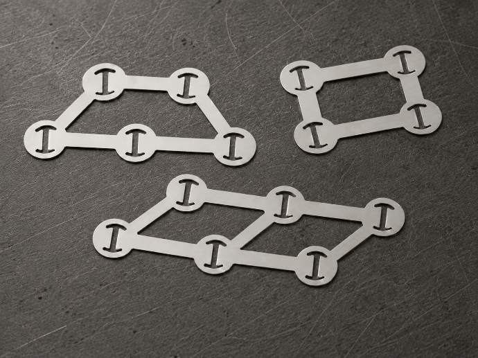 Laser-cut pure nickel tabs on workshop surface